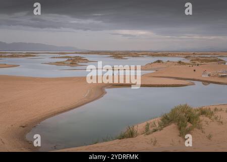 The lake in the middle of the desert. A unique landscape of Wuhai city in Inner Mongolia, China. Dramatic sky with copy space for text Stock Photo