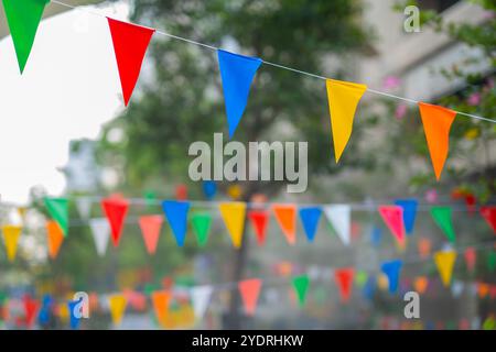 Decorative multi-colored triangle flags against the background at the festival in Thailand. Stock Photo