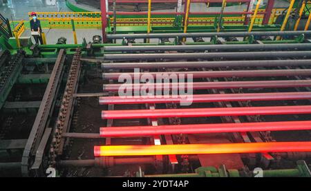 HUZHOU, CHINA - OCTOBER 28, 2024 - A worker works in a workshop of Zhejiang Minghe Steel Pipe Co., LTD., located in Moganshan High-tech Zone in Huzhou Stock Photo