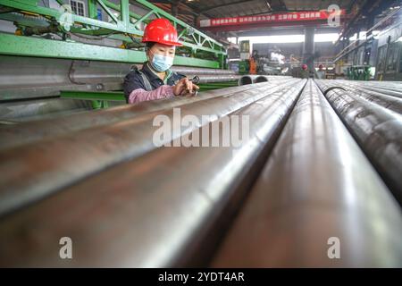 HUZHOU, CHINA - OCTOBER 28, 2024 - A worker works in a workshop of Zhejiang Minghe Steel Pipe Co., LTD., located in Moganshan High-tech Zone in Huzhou Stock Photo