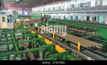 HUZHOU, CHINA - OCTOBER 28, 2024 - A worker works in a workshop of Zhejiang Minghe Steel Pipe Co., LTD., located in Moganshan High-tech Zone in Huzhou Stock Photo