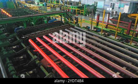 HUZHOU, CHINA - OCTOBER 28, 2024 - A worker works in a workshop of Zhejiang Minghe Steel Pipe Co., LTD., located in Moganshan High-tech Zone in Huzhou Stock Photo