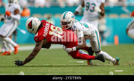 Miami Gardens, FL USA: Arizona Cardinals wide receiver Marvin Harrison Jr. (18) makes a reception and is tackled Miami Dolphins cornerback Cam Smith ( Stock Photo