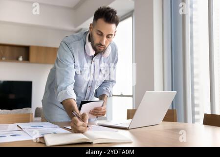 Serious focused project manager man doing research for startup Stock Photo