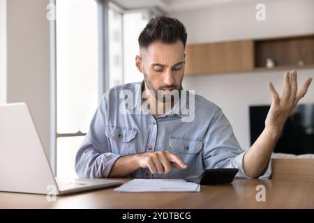 Worried Latin homeowner man finding money loss, financial problem Stock Photo