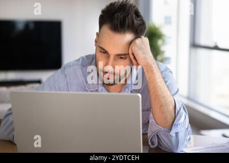 Tired Latin freelance entrepreneur man thinking on solutions for startup Stock Photo