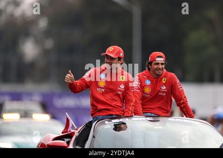 Mexico City. 27th Oct, 2024. Ferrari's Spanish driver Carlos Sainz (R) and Monegasque driver Charles Leclerc react during the parade through the streets before the Formula One Mexico Grand Prix at the Hermanos Rodriguez Circuit in Mexico City, Mexico on Oct. 27, 2024. Credit: Francisco Canedo/Xinhua/Alamy Live News Stock Photo