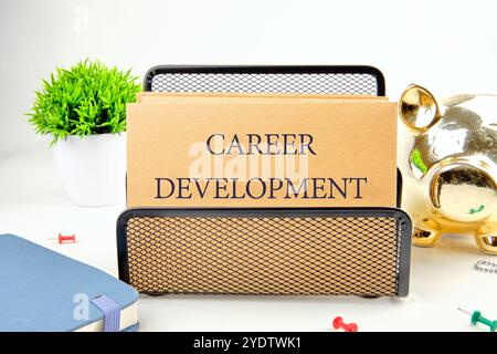 Business concept. The phrase, the text,the words CAREER DEVELOPMENT is written on paper in a black stand on a light background. Stock Photo