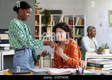 Collaborating on Academic Project in Modern Classroom Stock Photo