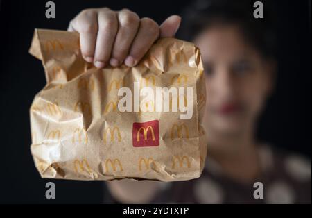 A take away pack of a McDonald's burger on October 26, 2024 in Guwahati, India. McDonald's recent food safety issues causing a 5% stock drop, after e- Stock Photo