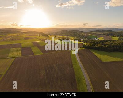 Sunset over sweeping fields with a winding road and dramatic sky, Gechingen, Black Forest, Germany, Europe Stock Photo