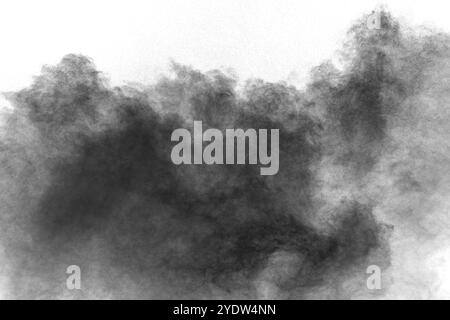 Black powder explosion against white background.Charcoal dust particles cloud Stock Photo