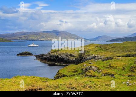 View South across Balmeanach Bay from Braes peninsula to Isle of Scalpay with the Calmac ferry, The Braes, Portree, Skye, Scotland Stock Photo