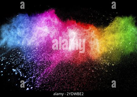 Multicolored powder explosion on black background. Color dust splash cloud on background. Launched colorful particles on background Stock Photo