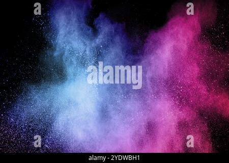 Multicolored powder explosion on black background.Blue pink dust particles splattered Stock Photo