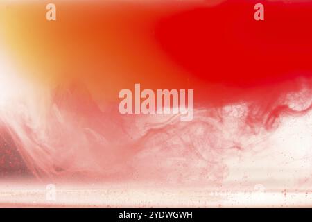 Colorful ink on white background.Yellow orange drop swirling under water. Cloud of acrylic paint in water Stock Photo