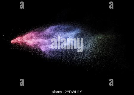 Multi color particles explosion on black background Stock Photo