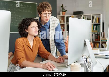 Collaborating on Educational Project in Modern Office Stock Photo