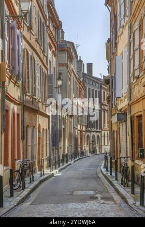 Narrow street in Toulouse historical center, France, Europe Stock Photo