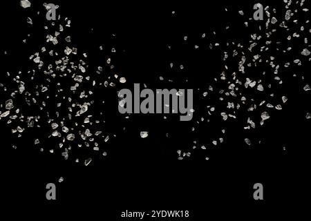 Split debris of stone exploding against black background Stock Photo
