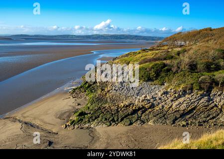 Rugged cliffs on the Jack Scout area of coast at Silverdale on Morecambe Bay. Seen at the point where the river Kent flows into the bay. Stock Photo