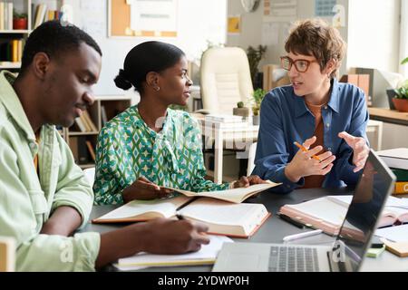 Collaborating on Work Project in Office Environment Stock Photo