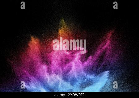 Multi colour powder explosion on black background. Launched colourful dust particles splashing Stock Photo