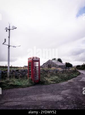 An abandonned red British telephone box on Dartmoor in Devon. Stock Photo