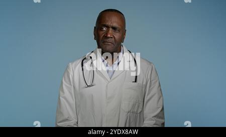Serious confused puzzled african american man doctor professional medical worker scientist laboratory assistant ethnic male physician look around Stock Photo