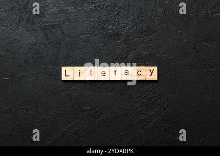 LITERACY word written on wood block. LITERACY text on cement table for your desing, concept. Stock Photo