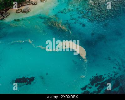 Plastic trash in ocean water. Ocean pollution, plastic in water on Bali. Aerial view. Stock Photo