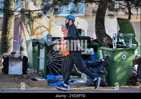 Montreal, Canada. 25th Oct, 2024. People jog by a homeless encampment on Notre-Dame street in the east end of Montreal, Friday, Oct. 25, 2024. Credit: The Canadian Press/Ģ����ý Live News Stock Photo