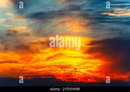 Colorful sunset blending warm tones of orange and pink in the evening sky. Fantastic colorful twilight with cloudy sky Stock Photo