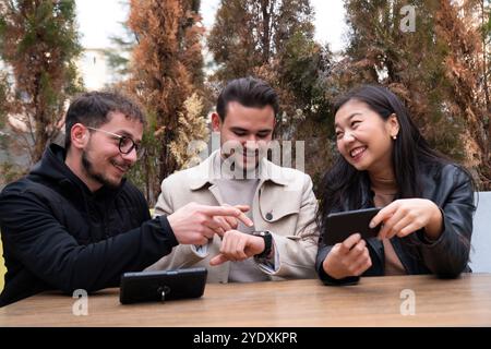 Young happy friends spending time during lunch in restaurant. Stock Photo