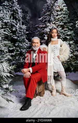 A charming winter background showcases a festive figure in red and a young skater dressed in white. Stock Photo