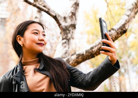young woman is taking a selfie with her cell phone Stock Photo