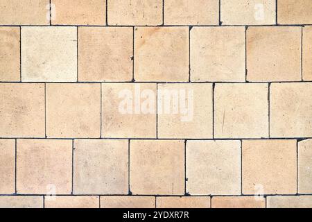 Orange brown white beige old shabby worn out floor tiles with damages cracks dirt caverns potholes and paint stains. Art retro grunge design backgroun Stock Photo