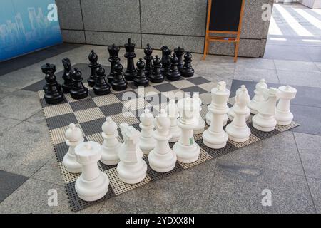 Giant chess game set on floor in public space. Diagonal angle. Ready to play anytime. Singapore. Stock Photo