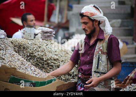 The historic Bab Al- Musa market in the Yemeni city of Taiz becomes very busy with residents shopping during Ramadan. The construction of the market of Bab Musa and the walls of the old city dates back to the Ottoman era in Yemen, with the market developing with the construction of the Bab Al-Musa Gate in the eighth century. Taiz remained a walled city until 1948 when Imam Ahmed allowed for expansion beyond its fortified wall. Taiz, which is located in south-western Yemen, is the third largest city in Yemen, and was its cultural capital until before becoming deeply entangled in the Yemeni conf Stock Photo