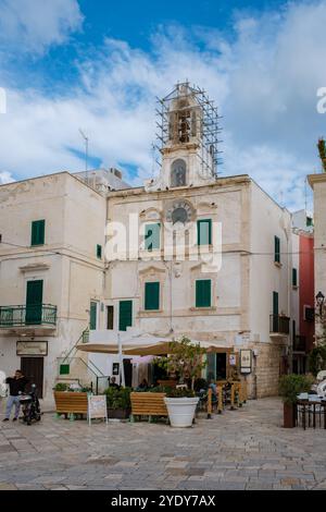 Polignano a Mare Italy 18 September 2024, Wandering through the delightful streets of Puglia, Italy, where historic architecture meets lively cafes, creating a captivating atmosphere on a bright day. Stock Photo