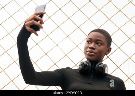female with wireless headset taking selfie Stock Photo