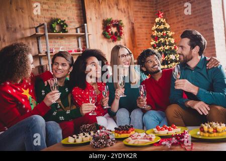 Photo of attractive young people enjoy champagne toast new year decoration interior celebrate home party apartment Stock Photo