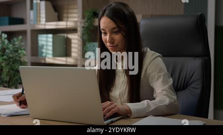 Caucasian analyst financial specialist busy business girl office worker manager entrepreneur female at workplace businesswoman woman writing notes Stock Photo