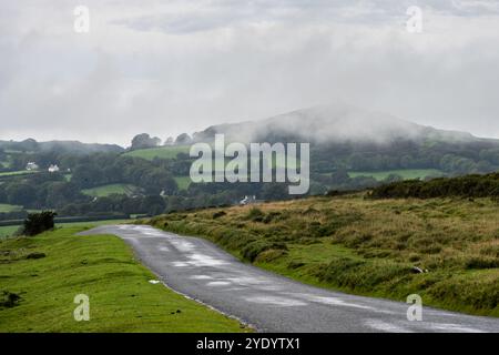 Low cloud passes over Brent Tor hill as seen from Mary Tavy on the edge of Dartmoor in West Devon. Stock Photo