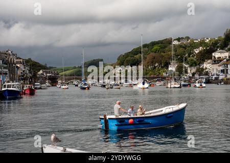 Tourists take a small passenger ferry across Looe Harbour in Cornwall, England. Stock Photo