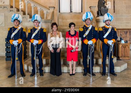 Silvia Berti and Dr. Giovanna Crescentini, two senior officials of the Republic of San Marino, in the hall of the Palazzo Pubblico, escorted by members of the Council Guard. Piazzale Domus Plebis, City of San Marino, San Marino. Stock Photo