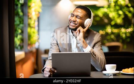 Young black businessman listening to music with headset Stock Photo