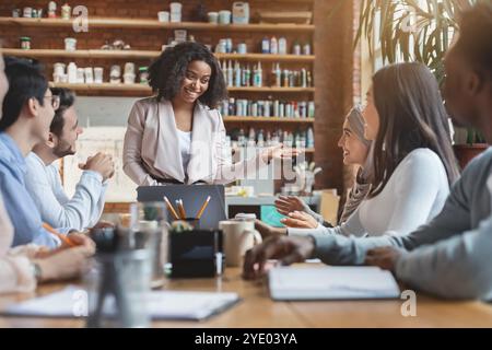Young afro woman manager leading morning briefing in office Stock Photo