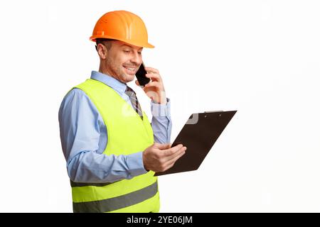 Construction Worker Talking On Phone Holding Folder Over White Background Stock Photo