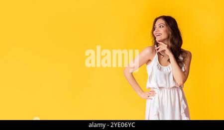 Beautiful lady in dress looking at copy space on colorful background Stock Photo